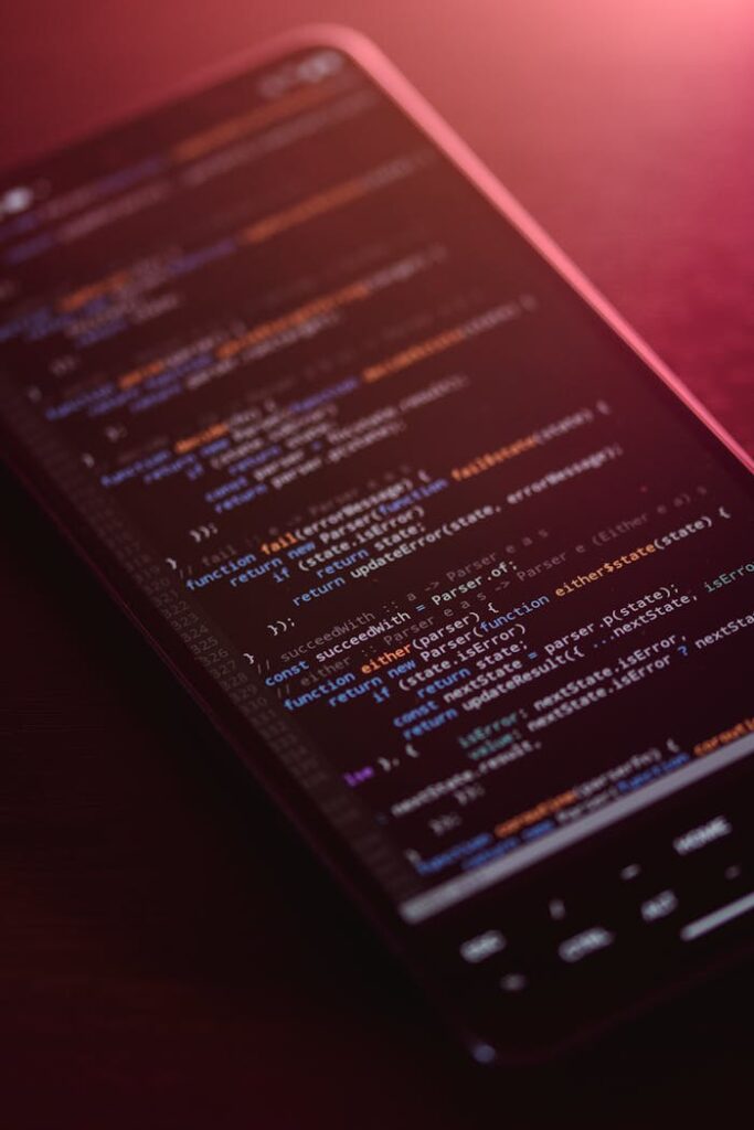 Colorful code displayed on a smartphone screen with a warm glow.